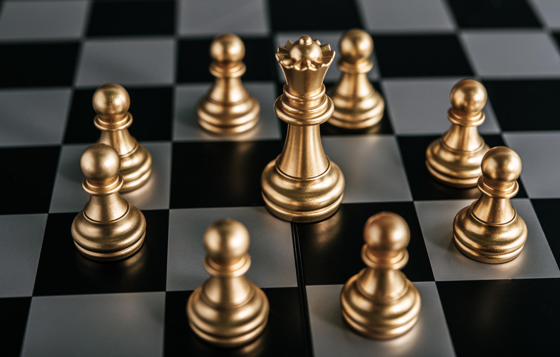 Gold chess pieces representing strategic business leadership